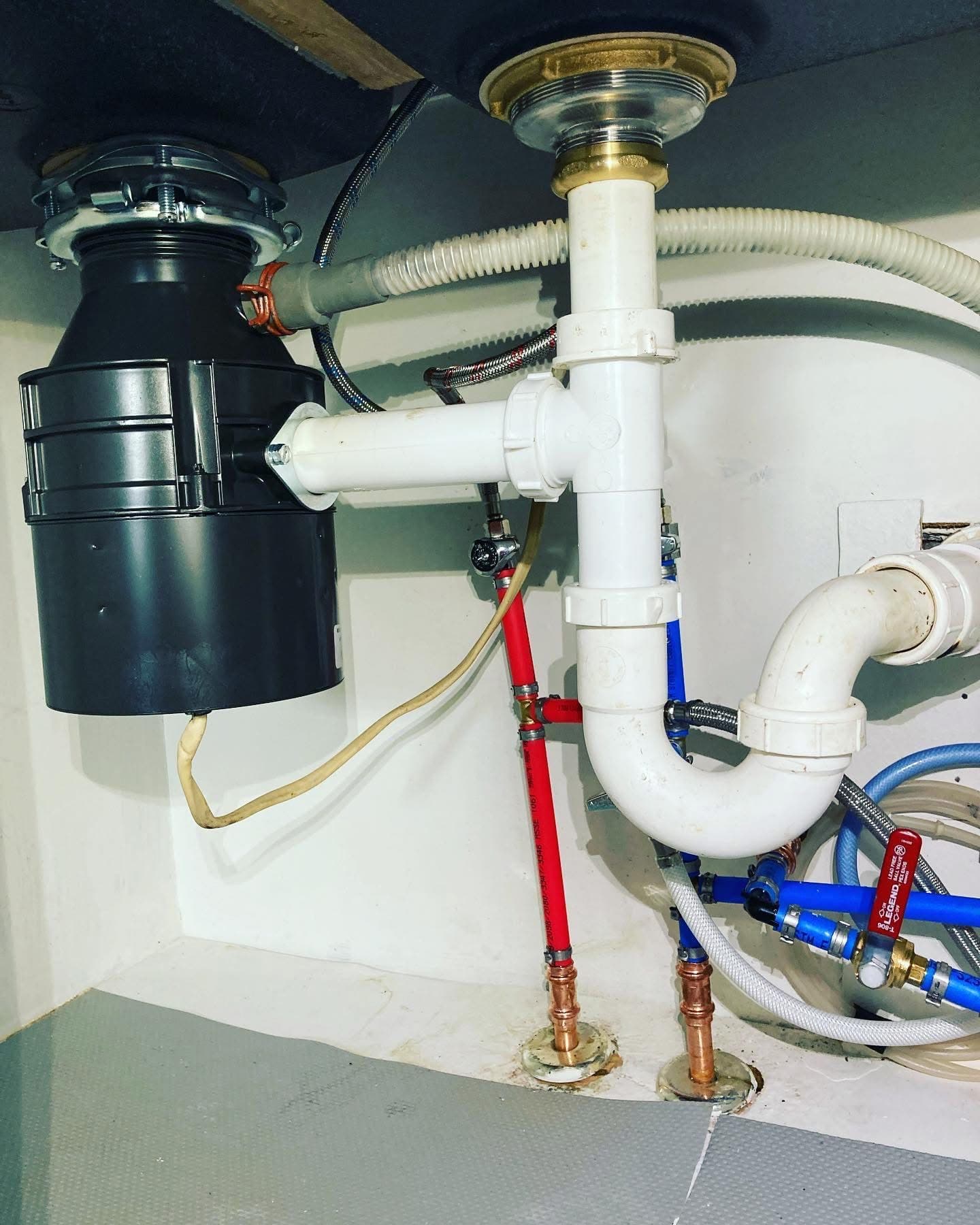 Garbage disposal and under-sink plumbing installation